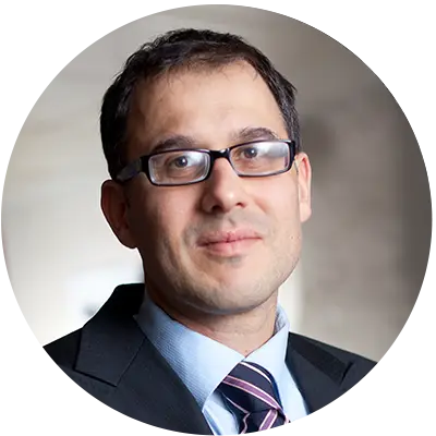 a man wearing glasses and a suit